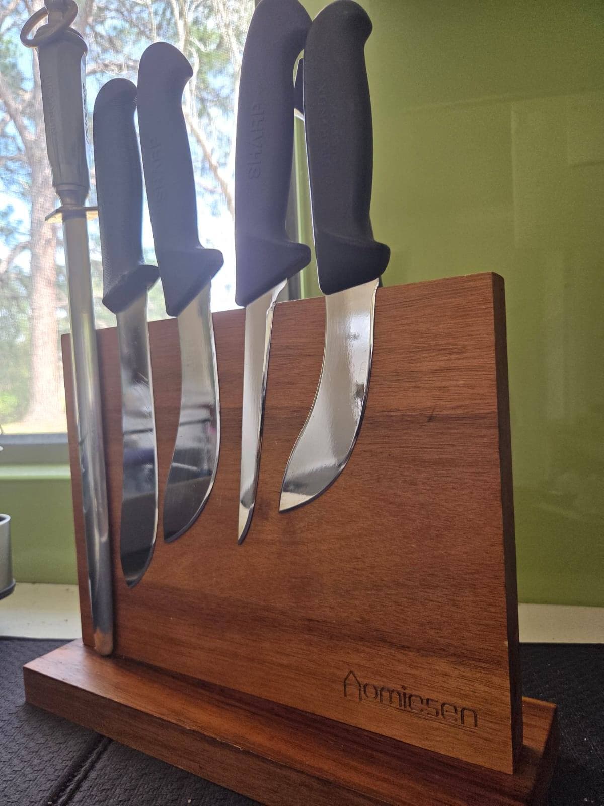 Butcher boning and skinning knives after sharpening, back on a magnetic knife block.