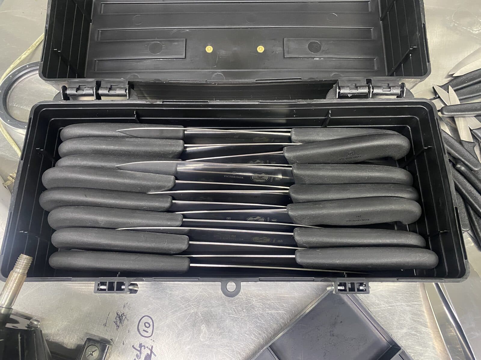 Variety of kitchen knives before sharpening.