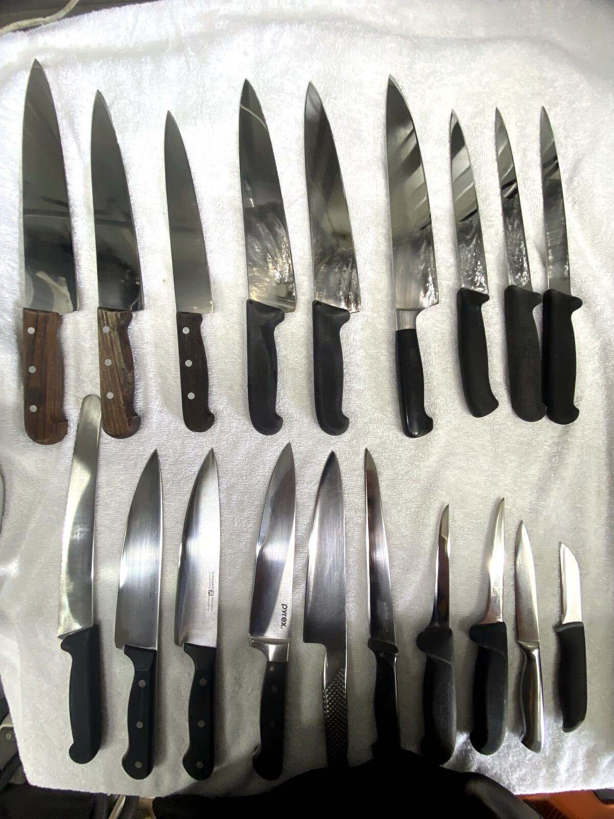 Professional knife lineup prepared for sharpening.