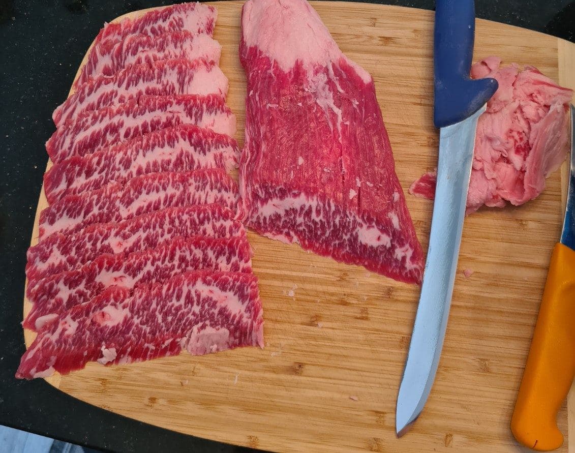 Thinly sliced wagyu beef cut with a butcher knife sharpened by Xtra Sharp.