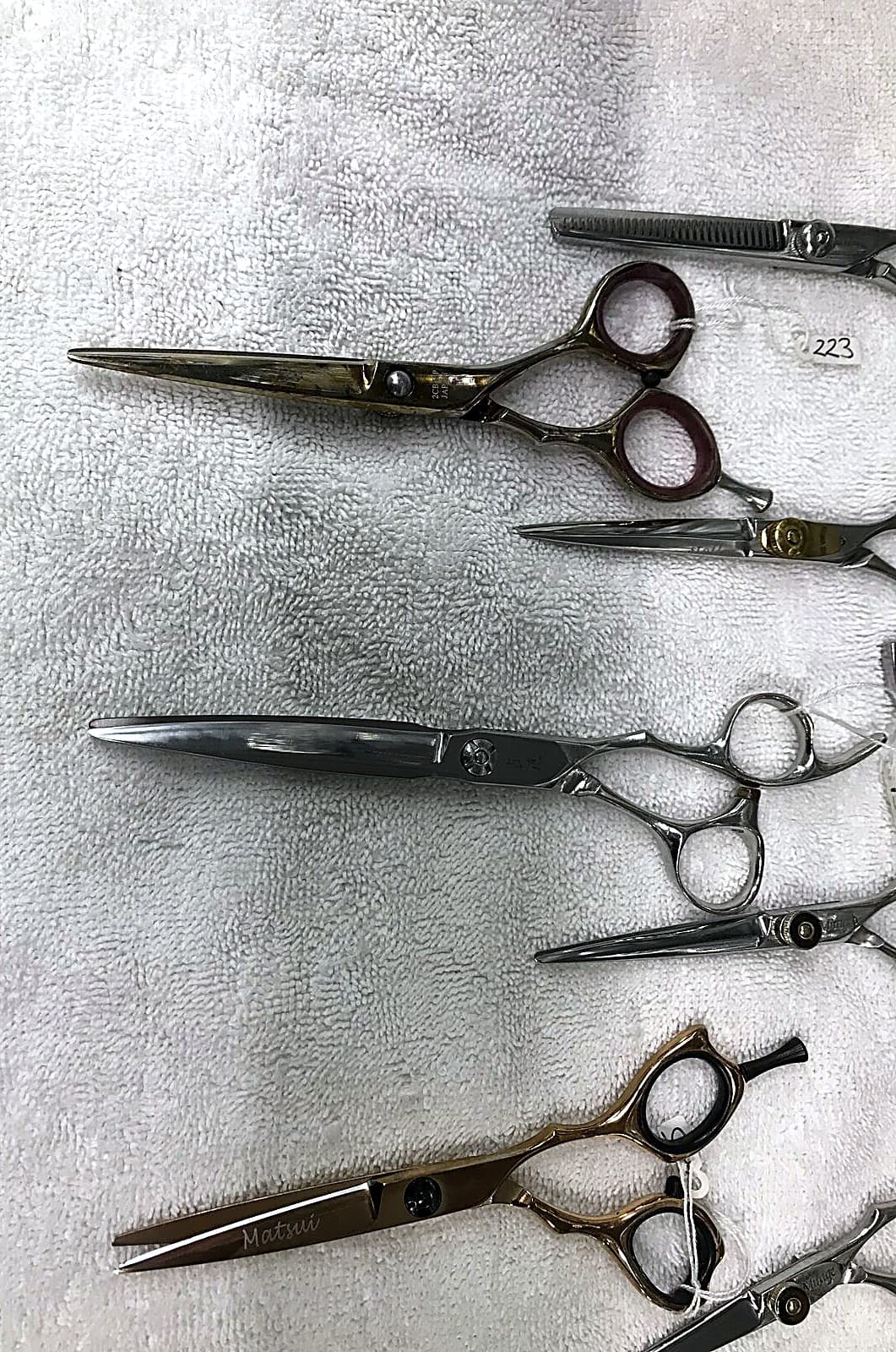 Hairdressing scissors lineup prepared for sharpening.